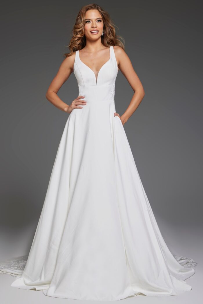 Model wearing Jovani JB42294 ivory gown with deep V-neck and A-line silhouette.