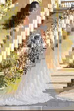 Back view of lace bridal gown with off shoulder floral sleeves and train