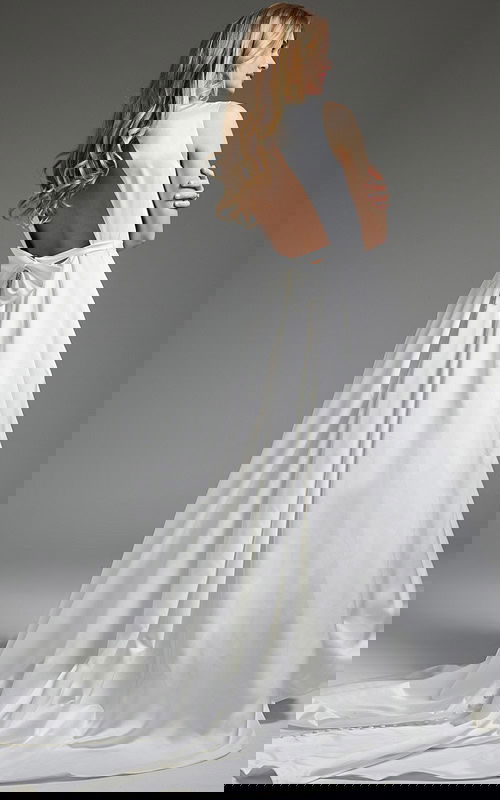 Model displaying JB42319 ivory gown, back view with bow detail and luxurious train