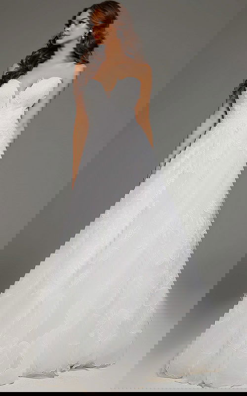 Full view of model in Jovani JB42324 ivory dress showcasing elegant silhouette and floral applique details.