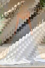 minimalist strapless wedding dress with structured bodice and long flowing train