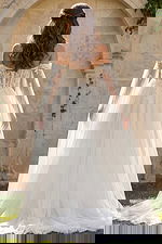 Romantic lace bridal gown with draped tulle sleeves and flowing skirt