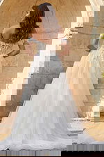 Strapless embroidered wedding dress with flowing tulle skirt and detachable sheer sleeves