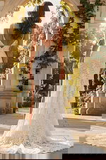 Back view of lace wedding dress with low V back and long flowing train