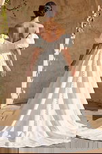 Romantic textured bridal dress with fitted bodice button back and flowing chapel train