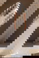 Fitted bridal dress with buttoned back and sheer veil