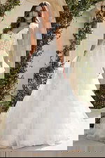 A-line wedding gown with layered tulle skirt, floral appliqué bodice, and 3D flower shoulder detail.