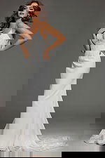 Model wearing Jovani JB43322 ivory gown with V-neckline and lace appliqués.