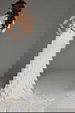 Model displaying the full length back of Jovani JB43322 gown with lace detailing and a soft train.