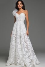 Model wearing Jovani JB43331 ivory gown with floral applique and sheer shoulder detail.