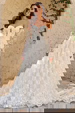 Lace off shoulder bridal gown with floral lace bodice, long sheer sleeves, and full A line skirt.