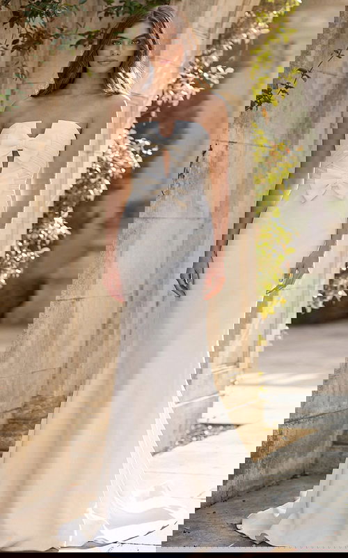 Front view of strapless bridal dress with double bow bodice and sleek silhouette