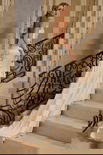 side view of an ivory wedding dress with bow detail JB45837