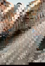 Back view of lace A line wedding gown with long veil and soft train