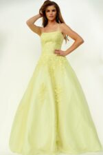 Model wearing Jovani 1831 ball gown in yellow, front view