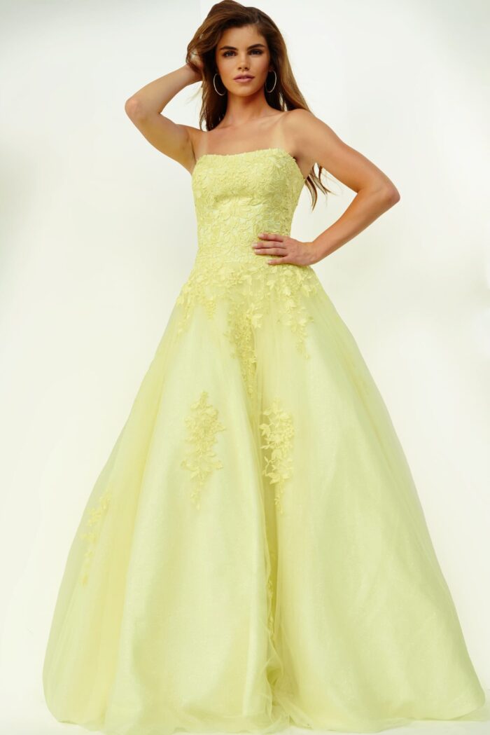 Model wearing Jovani 1831 ball gown in yellow, front view