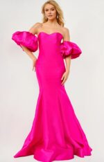 Model wearing Jovani 22830 fuchsia gown with sweetheart neckline and puff sleeves.