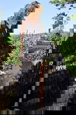 Model wearing JVN22904 black gown with deep V-neck and ruffled skirt front view