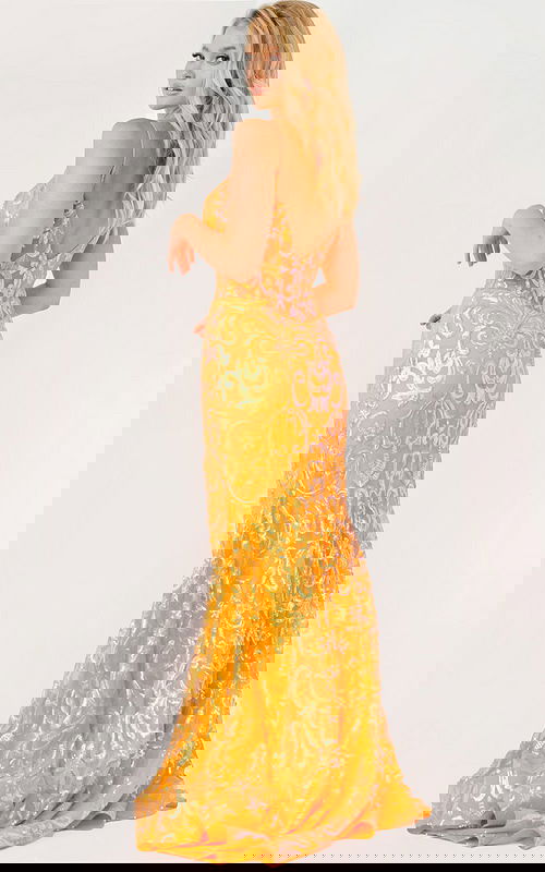 Model wearing Jovani 23216 orange dress, showcasing low back detail.