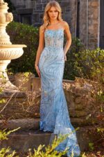 Model wearing Jovani 23250 blue gown with spaghetti straps and sequins.