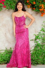 Model wearing Jovani 23250 fuchsia gown with sequin embellishments.