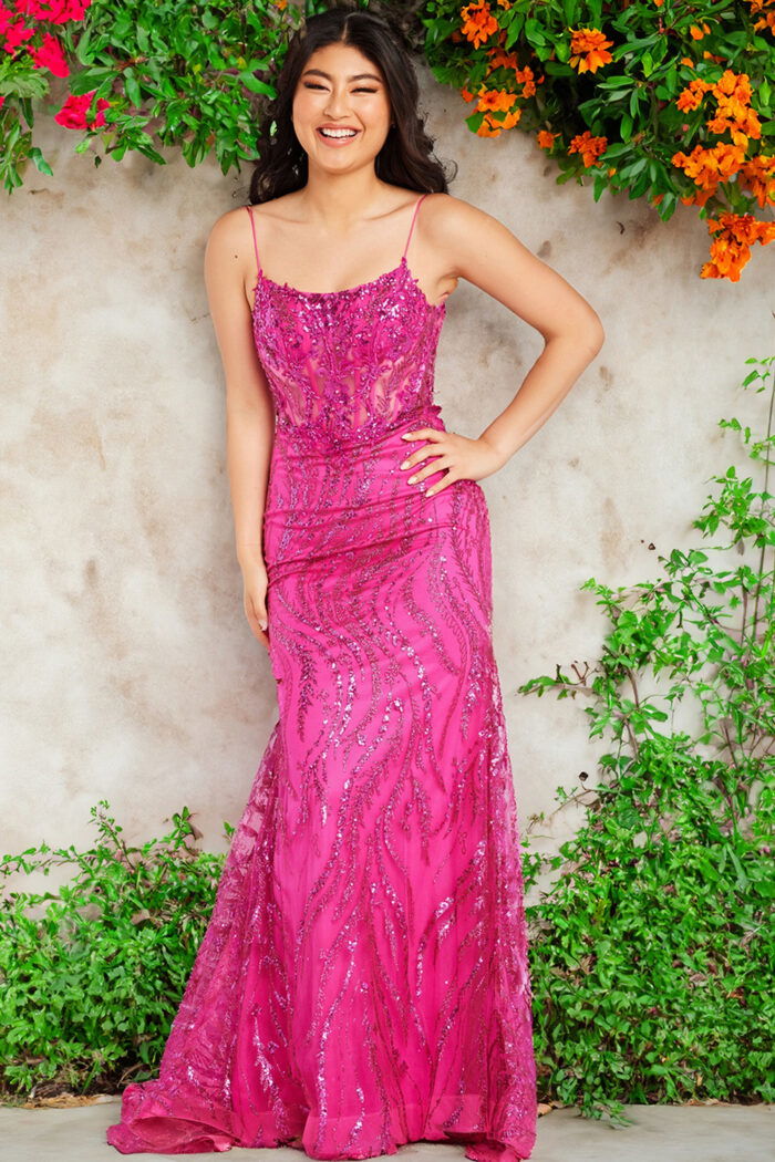 Model wearing Jovani 23250 fuchsia gown with sequin embellishments.