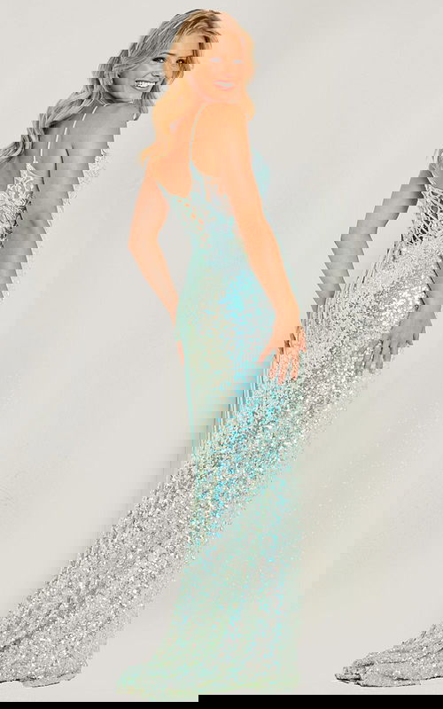 Model wearing Jovani 24299 blue gown with sheer back and lace-up detail