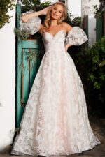Model posing in Jovani 37531 full-length pink dress with puff sleeves.