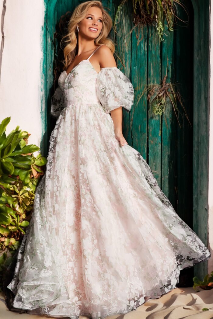 Model side view of Jovani 37531 pink gown with floral lace and puff sleeves.