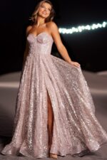Model in Jovani 38607 blush dress with shimmering sequins and slit.