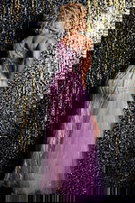 Model wearing Jovani 39385 blush gown showing back detail with elegant beadwork.