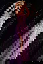 Model wearing Jovani 39385 blush gown with one-shoulder neckline and high slit, front view.