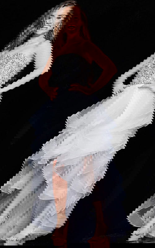 Model wearing Jovani K05916, a white dress with a sequin bodice and high-low tulle skirt, front view.