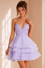Model wearing Jovani K06062 lilac dress with sweetheart neckline and tiered skirt, front view.