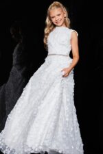 Model in Jovani K07245 ivory gown showcasing a high round neckline and floral design.