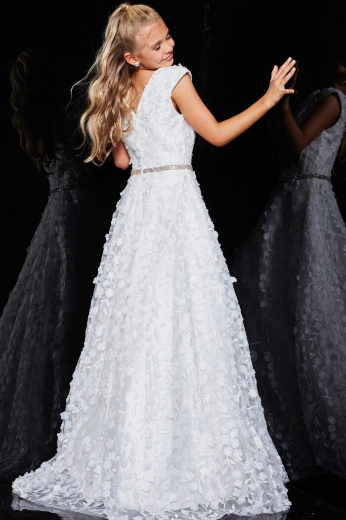 Back view of model in Jovani K07245 ivory gown with cap sleeves and floral appliqué.