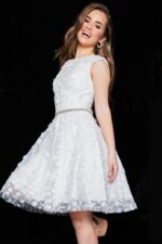 Ivory K07246 dress with floral appliqués and a beaded waistband, modeled elegantly.