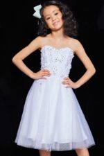 Child model in Jovani K07817 dress, white color with floral lace detailing, front view.