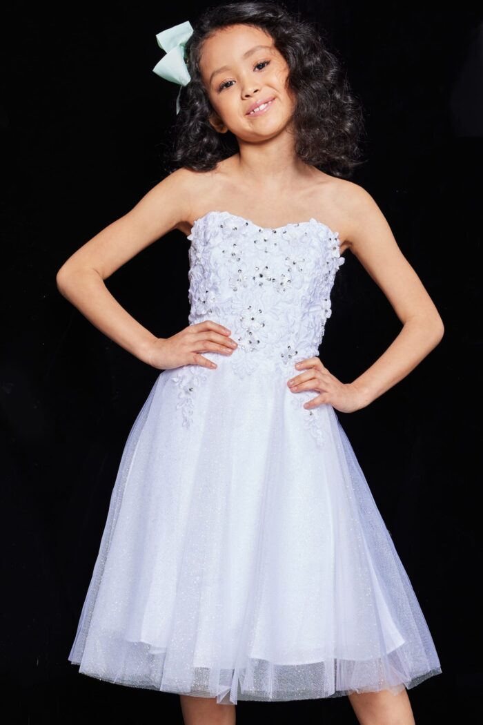 Child model in Jovani K07817 dress, white color with floral lace detailing, front view.