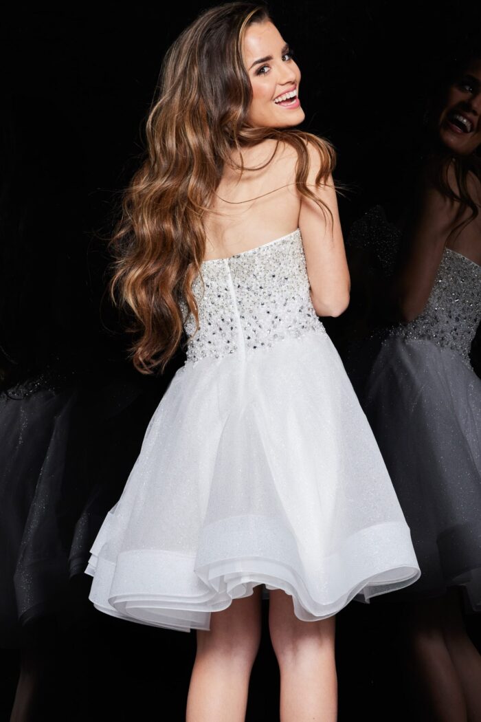 Back view of model wearing Jovani K24050 ivory dress with embellishments.