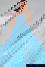 Model wearing Jovani K25988 light blue gown with floral appliques, full front view.