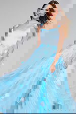 Model in Jovani K25988 light blue gown with floral details, front view.