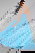 Model showcasing the back of Jovani K25988 light blue gown with floral appliques.