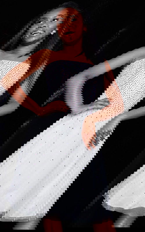 Front view of model wearing Jovani K2830 white dress with embellishments.