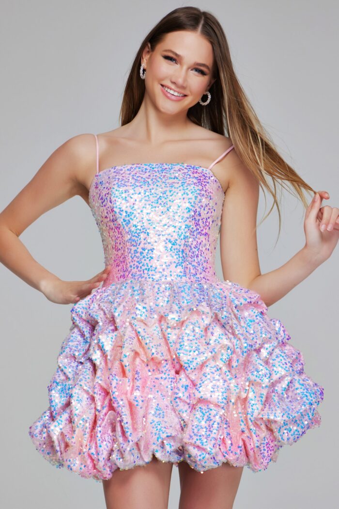 Model in K38108 pink dress with a shimmering sequined top and ruffled A-line skirt.
