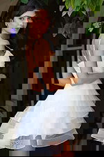 Jovani K45884 ivory spaghetti strap short dress side back view showing beaded straps, pearl embellished bodice, low open back, and multi tiered organza ruffle skirt