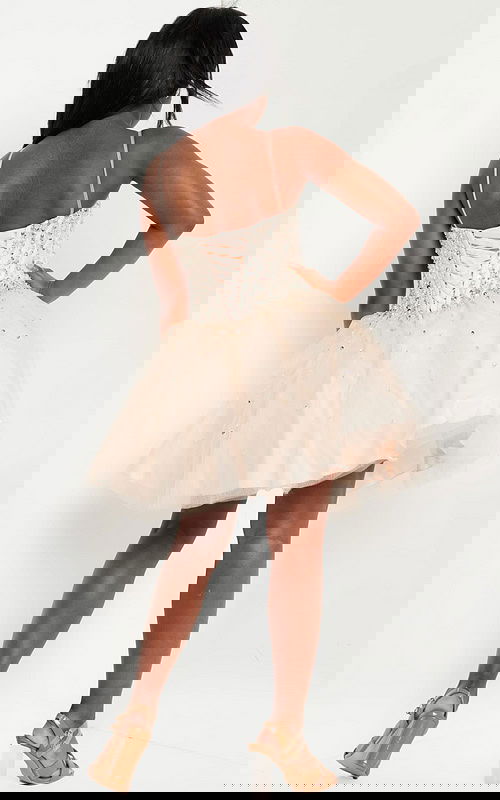 Model showing back of Jovani K59903 in blush with lace-up detail