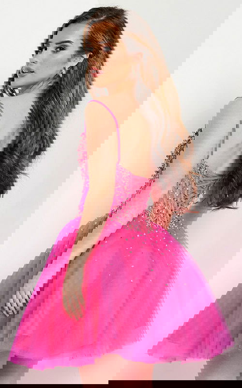 Model wearing Jovani K62533 fuchsia dress showing the back lace-up design.