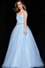 Model wearing Jovani K66712 blue ball gown with full skirt in motion.