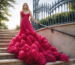 Fuchsia strapless evening gown with a voluminous ruffled skirt